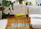 Modern living room with white furniture, plants, and a large window.